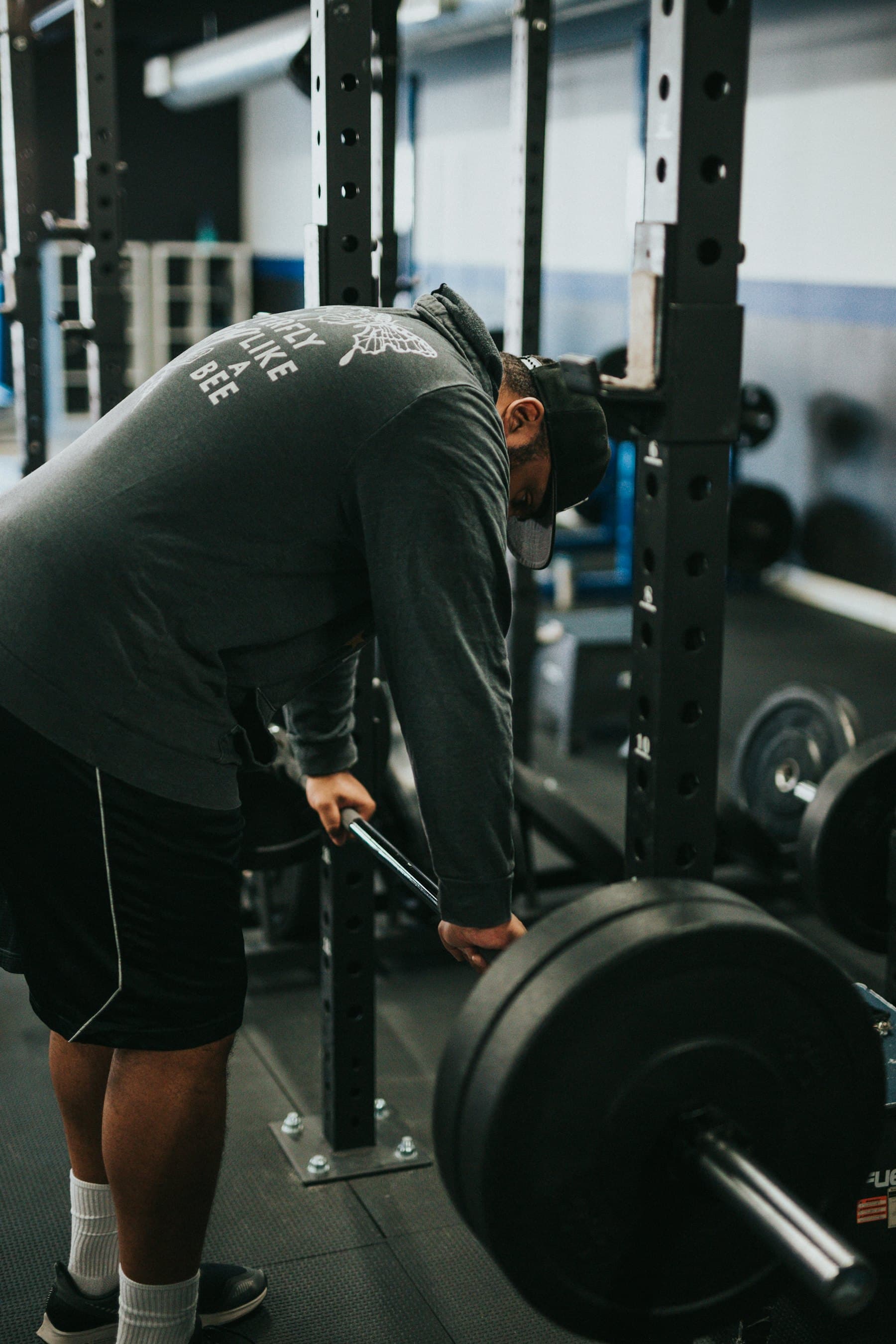 A coach loading a barbell