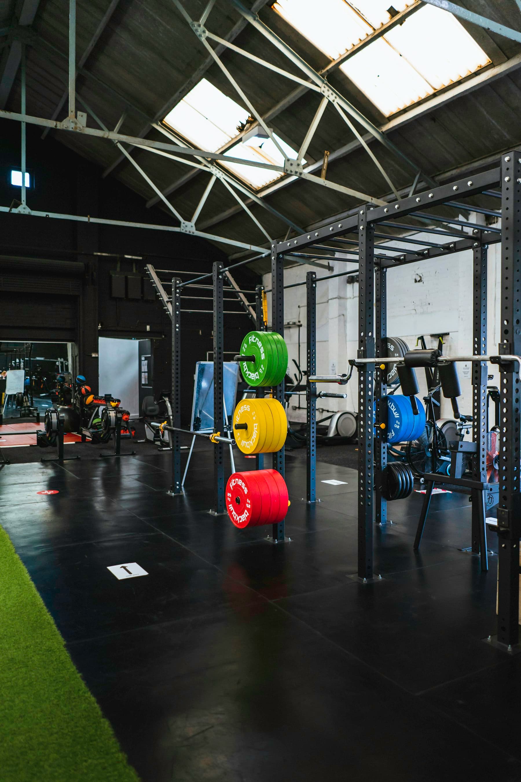 Weight plates racked on the gym floor